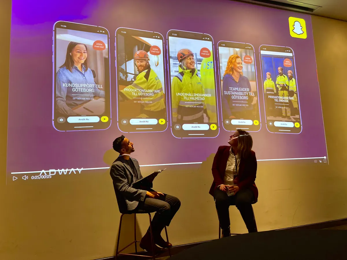 Speakers on stage beside examples of Adway Snapchat recruitment ads